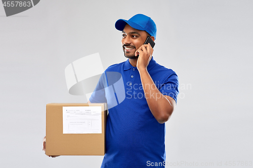 Image of indian delivery man with smartphone and parcel box