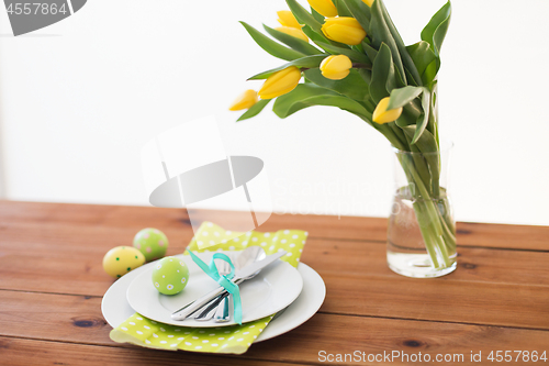 Image of easter egg in cup holder, plates and cutlery