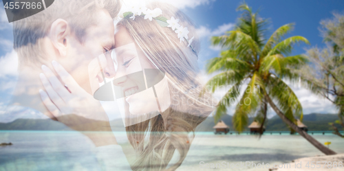 Image of hippie couple fading over exotic beach background