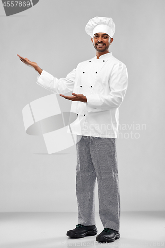 Image of happy male indian chef in toque