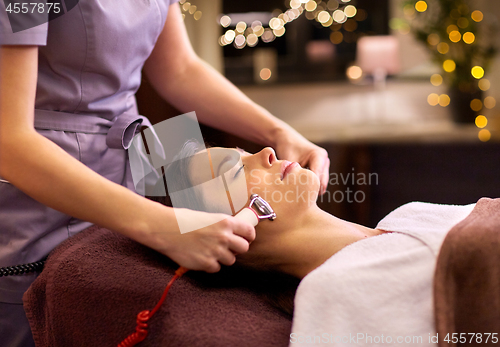 Image of woman having hydradermie facial treatment in spa