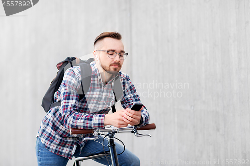 Image of hipster man with fixed gear bike and backpack