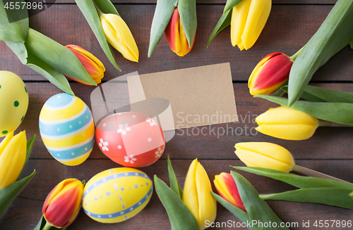 Image of close up of colored easter eggs and tulip flowers