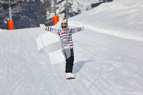 Image of Female snowboarder using ski lift