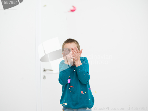 Image of kid blowing confetti