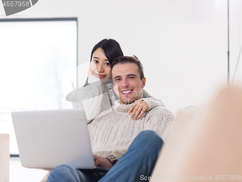 Image of multiethnic couple using laptop computers