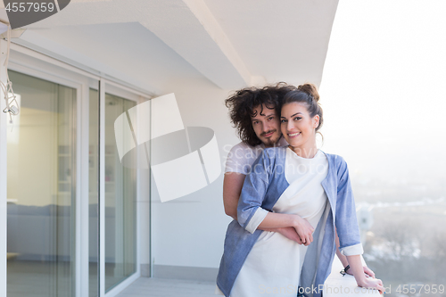 Image of Couple hugging on the balcony