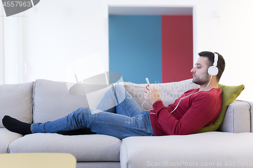 Image of man enjoying music through headphones