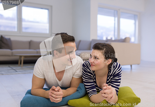 Image of couple lying on the floor at home