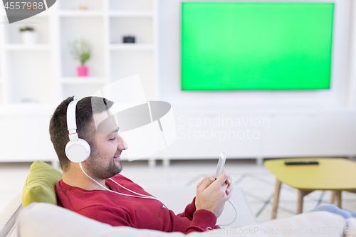 Image of man enjoying music through headphones