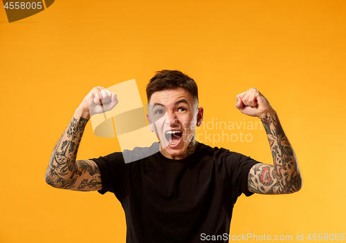 Image of Winning success man happy ecstatic celebrating being a winner. Dynamic energetic image of male model