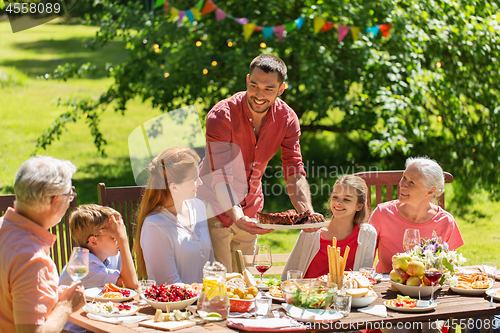 Image of happy family having dinner or summer garden party