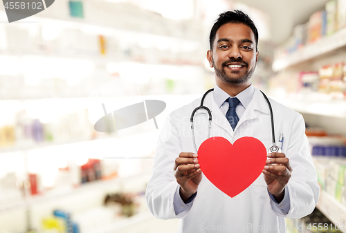 Image of smiling indian male doctor with red heart shape