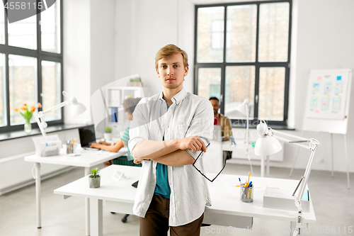 Image of man with glasses at office