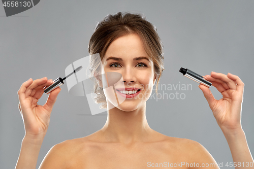 Image of woman with mascara applying make up