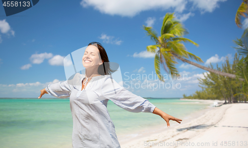 Image of happy woman over tropical beach background