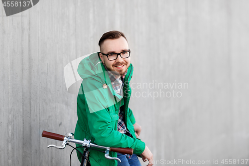 Image of happy young hipster man with fixed gear bike