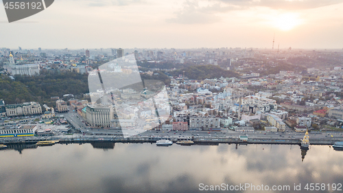 Image of The panoramic bird\'s eye view shooting from drone of the Podol district, the right bank of the Dnieper River and centre of Kiev, Ukraine at summer sunset on the background of the cloudy sky.