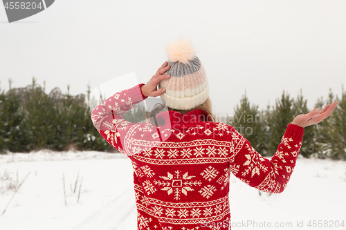 Image of Female standing in a winter landscape covered in snow