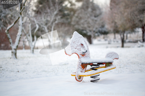 Image of Child playground equipment covered in snow in Oberon