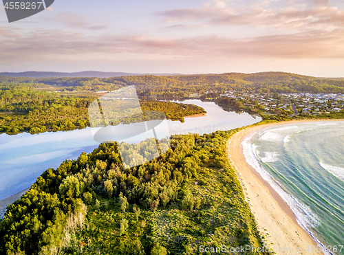 Image of Early morning light over coastal beaches and river