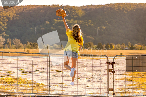 Image of Aussie woman standing on a rural farm gate