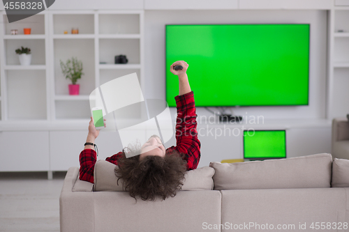 Image of young man in bathrobe enjoying free time