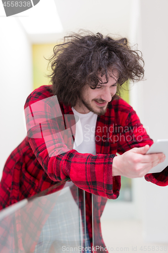 Image of young freelancer using tablet computer