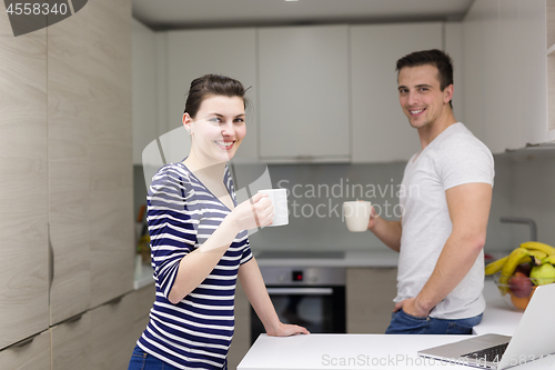 Image of couple with laptop computer enjoying morning