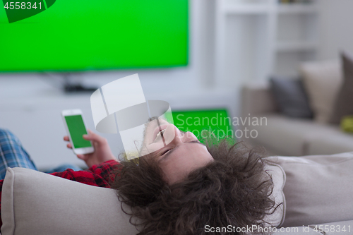 Image of young man in bathrobe enjoying free time