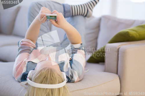 Image of girl enjoying music through headphones