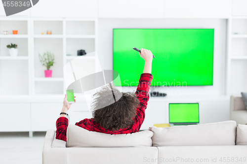 Image of young man in bathrobe enjoying free time