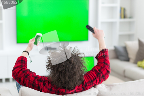 Image of young man in bathrobe enjoying free time