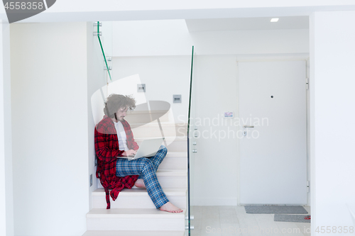 Image of freelancer in bathrobe working from home
