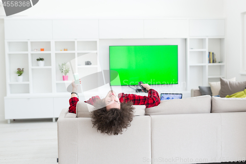 Image of young man in bathrobe enjoying free time