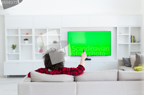 Image of young man in bathrobe enjoying free time