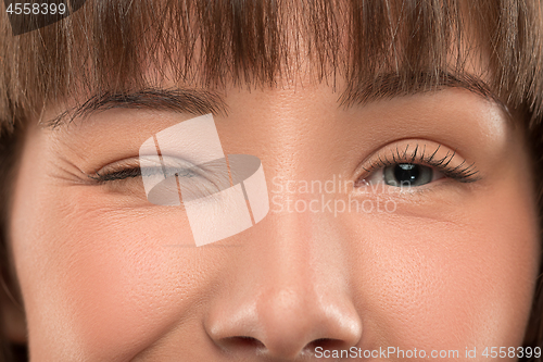 Image of Close up portrait of a pretty young woman winking