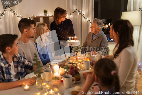 Image of happy family having birthday party at home