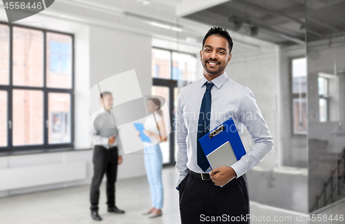 Image of indian businessman or realtor in empty office room