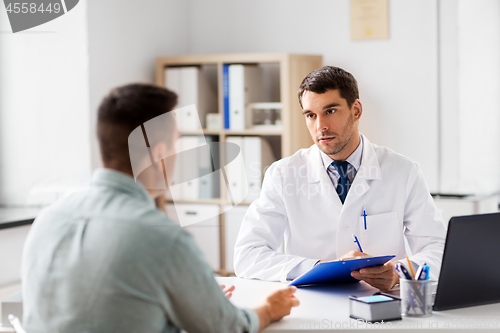 Image of doctor with clipboard and male patient at hospital