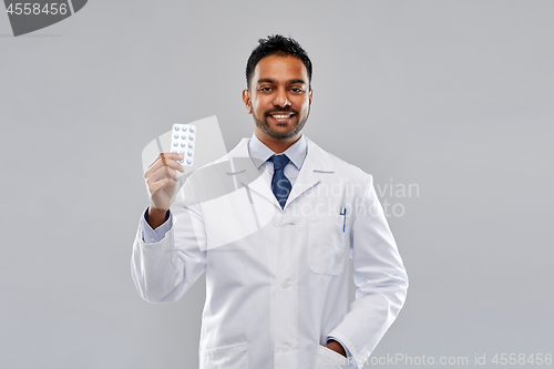 Image of indian male doctor or pharmacist with pills