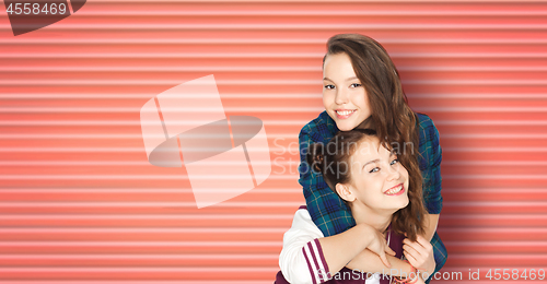 Image of happy smiling teenage girls or friends hugging