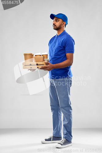 Image of happy indian delivery man with food and drinks