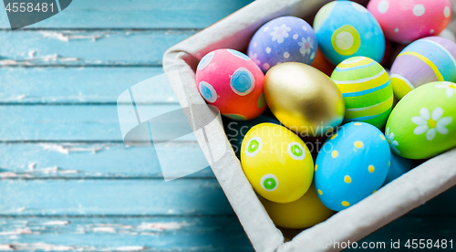 Image of close up of colored easter eggs in basket