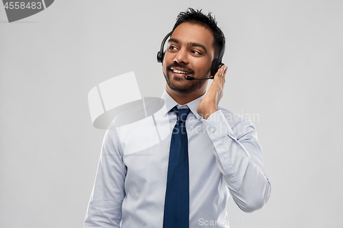 Image of indian businessman or helpline operator in headset