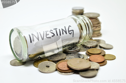 Image of Investment lable in a glass jar with coins spilling out