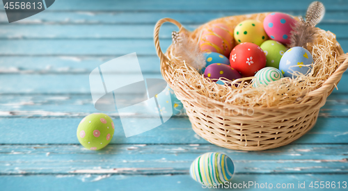 Image of close up of colored easter eggs in basket