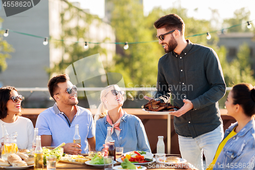 Image of friends at bbq party on rooftop in summer