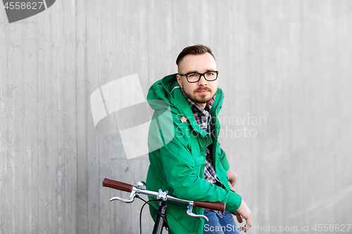 Image of happy young hipster man with fixed gear bike