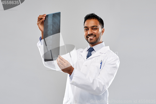 Image of smiling indian doctor looking at spine x-ray